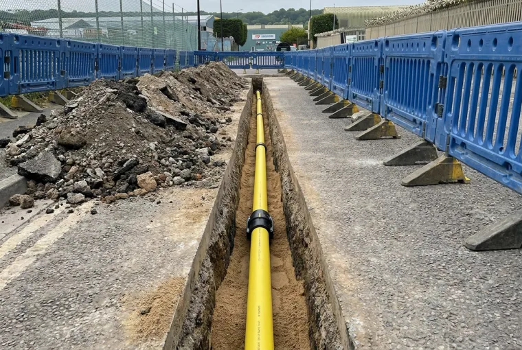 Yellow MDPE gas main laid in a clean saw-cut trench during installation