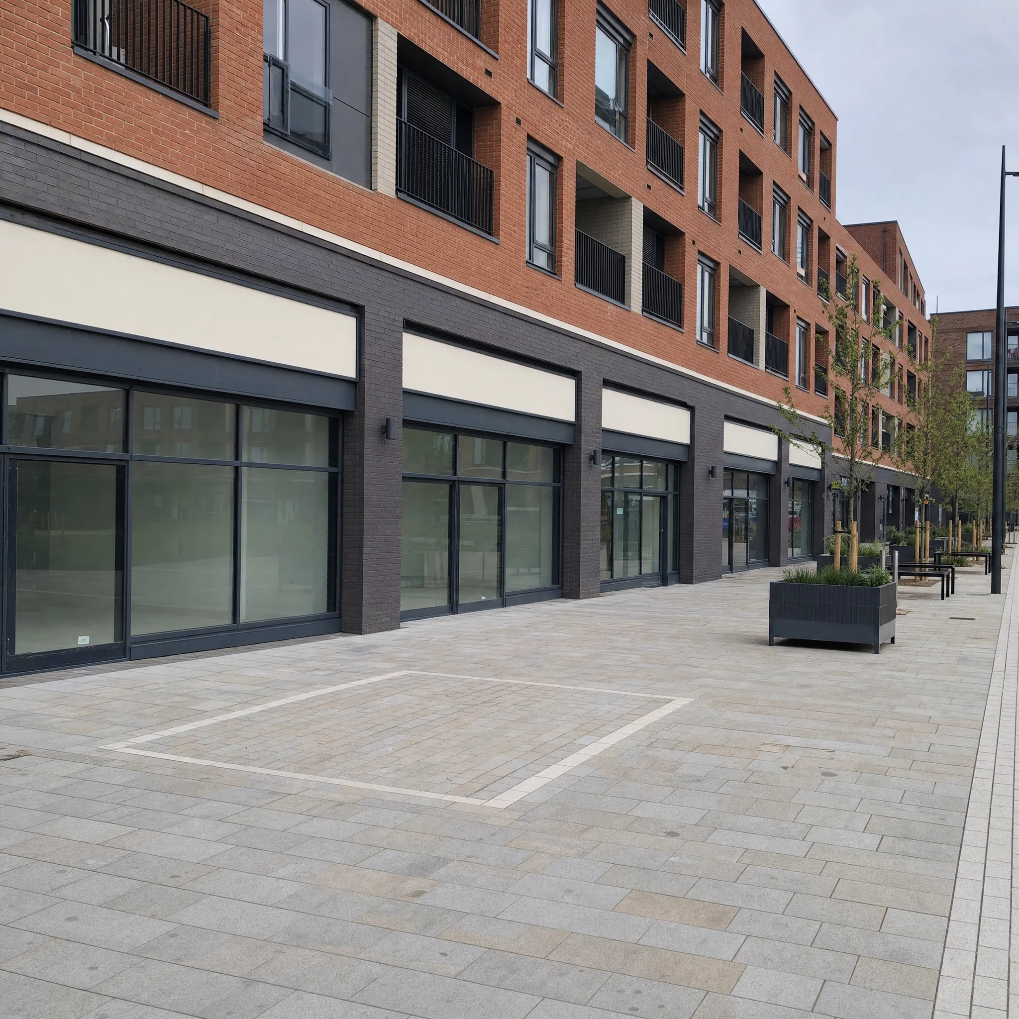 UK mixed-use development with ground-floor retail under a residential block